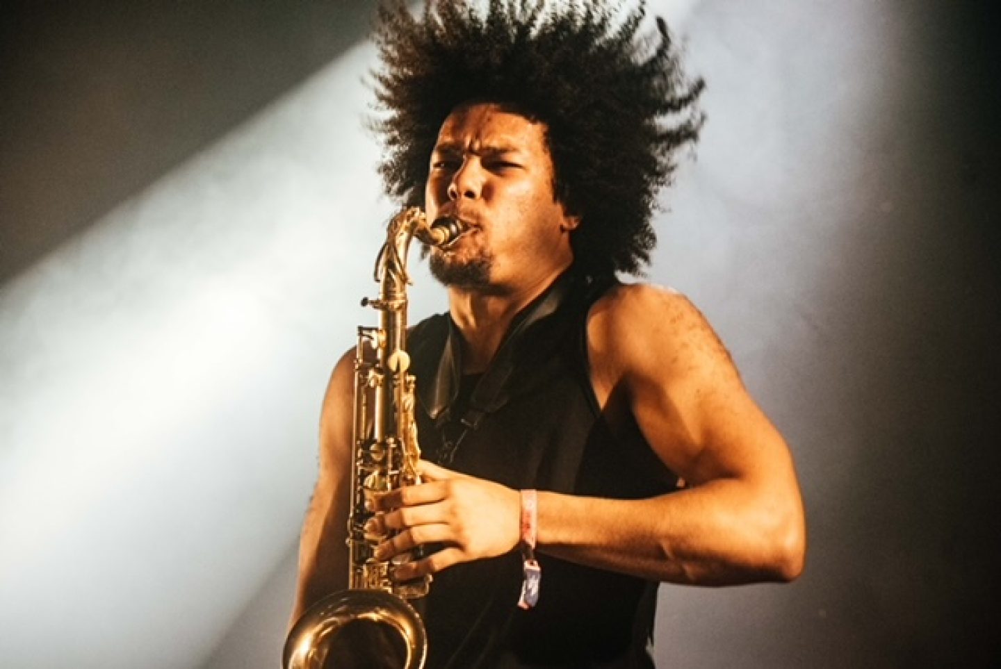 A person playing a saxophone. A person playing a saxophone.