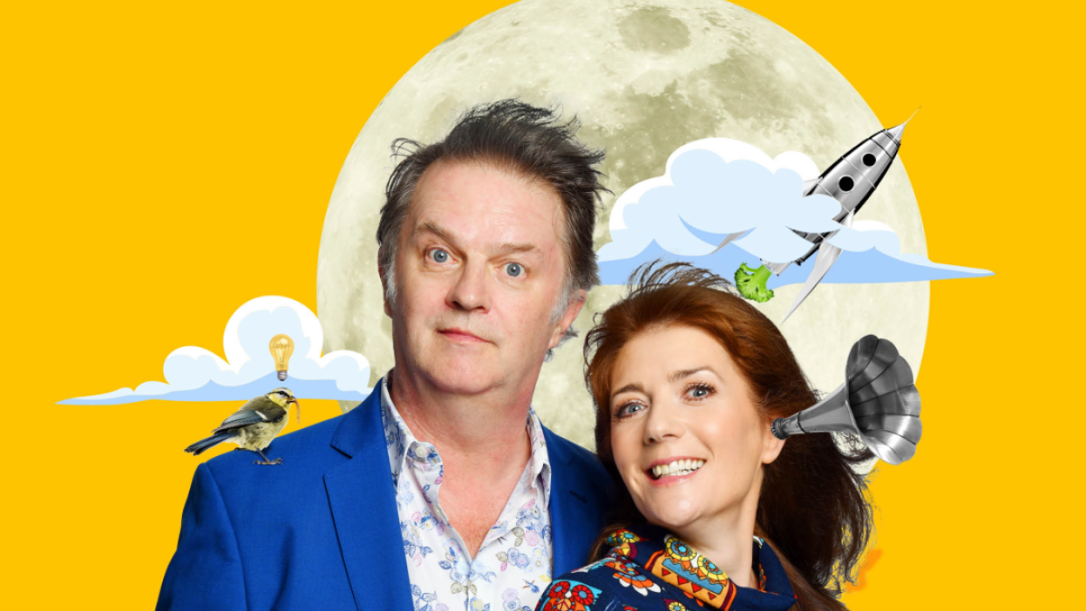 A man and a woman stand together against a bright yellow background with playful moon and airplane graphics.