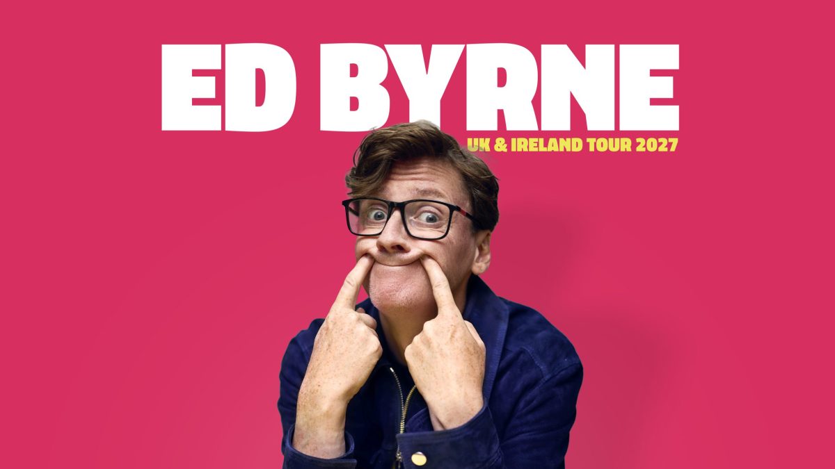 Bright promotional poster with a vivid pink background. Large bold white text at the top reads “ED BYRNE,” with smaller yellow text beside it saying “UK & IRELAND TOUR 2027.” In the foreground, a person wearing glasses and a dark jacket faces forward, pressing their fingers into both cheeks to stretch their mouth into an exaggerated expression. At the bottom, partially visible yellow text reads “NO DRAMAS.”